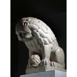 An Italian carved Verona marble group of a lion and cub in Romanesque style, both peering over a