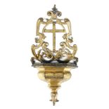A mid-18th century continental gilt bronze holy water stoup, the pierced back centred with a
