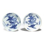 A matched pair of Chinese porcelain blue and white saucer dishes, each decorated with scaly