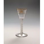 A Giles-decorated wine glass c.1770, the rounded funnel bowl moulded with twelve flutes and