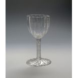 A fine glass goblet c.1750, the generous rounded bowl moulded with wide ribs above an incised