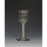 An unusual wine glass c.1765, with a generous tulip bowl on a double series opaque twist stem