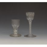 A small wine glass c.1765, the ogee bowl engraved with a continuous formal border, on a double