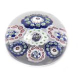 A Baccarat spaced paperweight c.1850, set with six rings of canes in red, blue, green and white