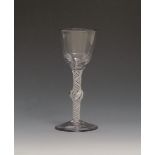 A large wine glass c.1760, with a generous ogee bowl raised on a knopped opaque twist stem above a