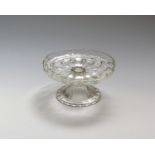 A low glass tazza or salver c.1730, the shallow tray with everted rim, moulded to the underside with