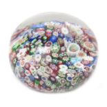 A small Baccarat millefiori paperweight c.1850, set with a multitude of colourful canes, 6cm dia.