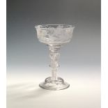 A fine champagne or mead glass c.1760, the wide ogee bowl engraved with a continuous band of