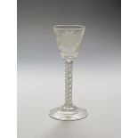 A mixed twist wine glass c.1765, the rounded funnel bowl engraved with a sunflower spray, raised