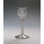 A 'Britannia' wine glass c.1765, the ogee bowl engraved to one side with an oval panel enclosing