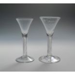 Two large wine glasses c.1760, with drawn trumpet bowls rising from thick airtwist stems above