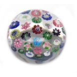 A large Clichy spaced paperweight c.1850, set with a variety of colourful canes including two Clichy