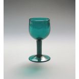 A green wine glass c.1760, with generous rounded bowl raised on a plain stem above a conical foot,