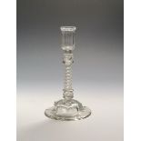 A rare glass candlestick c.1750, the ribbed cylindrical nozzle raised on a composite stem of a