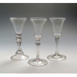 Three Continental wine glasses 1st half 18th century, one with a funnel bowl raised on a baluster