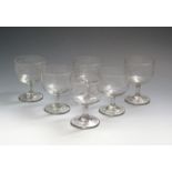 Six Irish glass engraved rummers 19th century, probably Cork, the rounded cup bowls engraved with