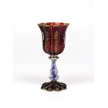 A Bohemian glass goblet 19th century, the fluted ruby glass bowl gilded with foliate scrolls, raised