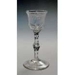 A wine glass of Jacobite type c.1765, the bowl engraved with a continuous band of flowers