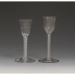 Two small wine glasses c.1760, with rounded funnel bowls, one with vertical moulded flutes, the