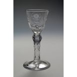 A good engraved wine glass c.1765, decorated with a flower spray and a single bee, raised on a six-