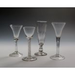 Four wine glasses c.1750-70, one with a slender bell bowl, another a drawn trumpet bowl, both raised