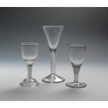 Three wine glasses c.1760-70, the largest with a drawn trumpet bowl on an airtwist stem, the