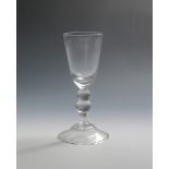 A toastmaster's goblet c.1740-50, the tall funnel bowl raised on a double-knopped baluster stem