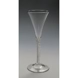 A flute wine glass c.1760-70, the slender drawn trumpet bowl rising from a dense airtwist stem above