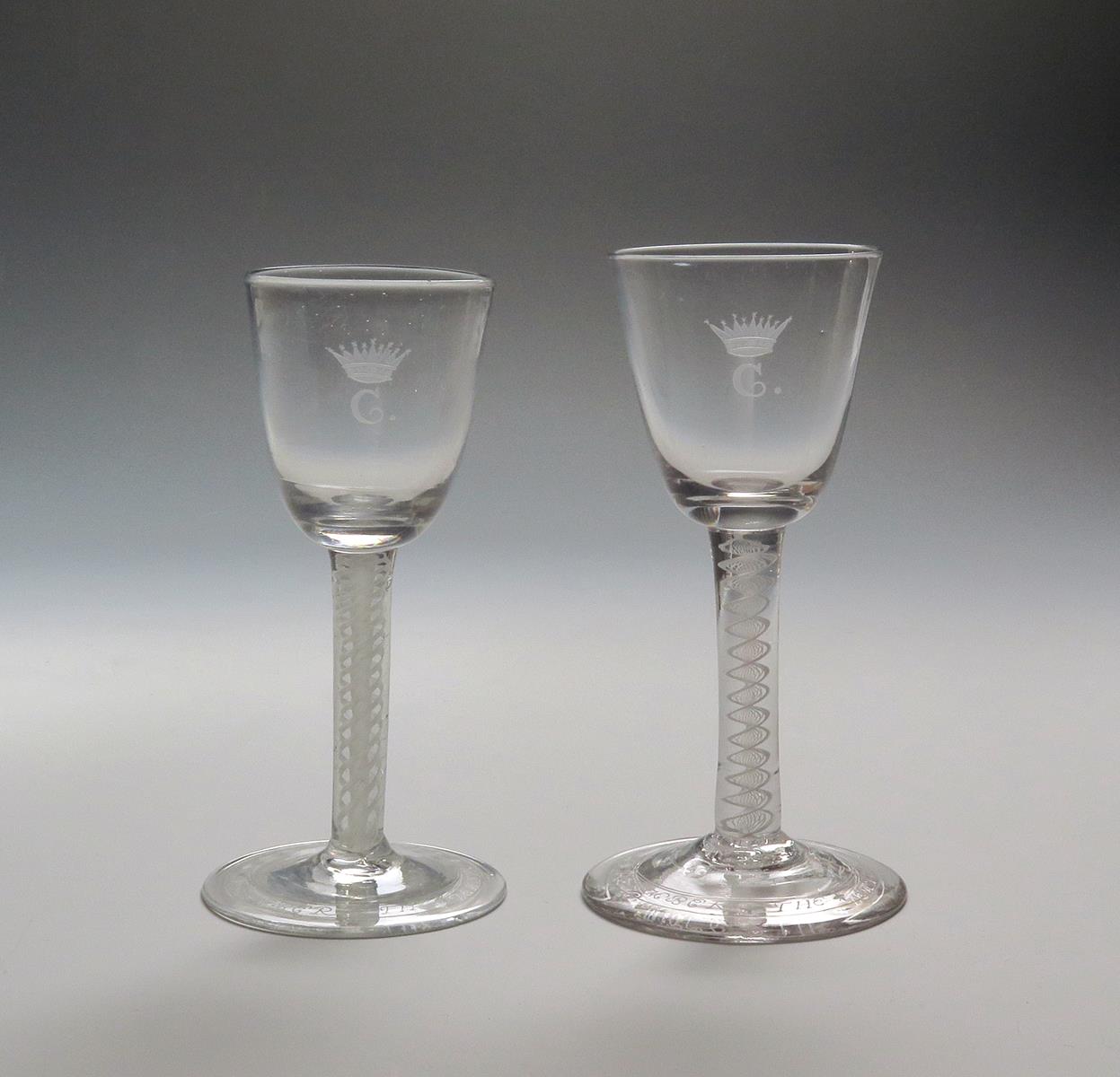 A pair of wine glasses c.1770, one English, one Dutch, the round funnel bowls later engraved with
