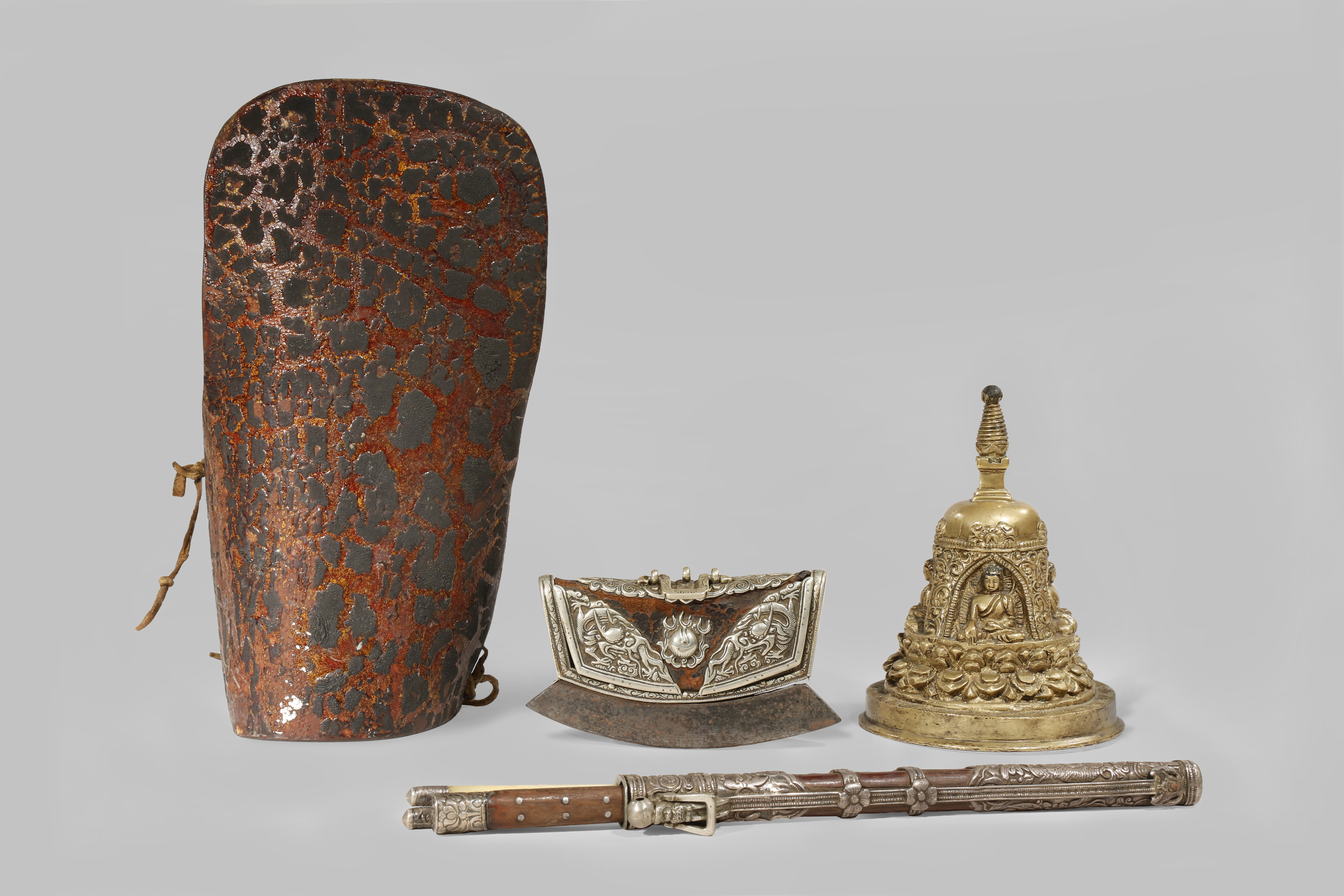 A COLLECTION OF TIBETAN ITEMS 15TH CENTURY AND LATER Comprising: a brass alloy stupa, a small purse,