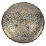 An Indo-Persian shield (dhal), of gilt copper, the outer surface engraved in low relief with