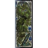 A William De Morgan Persian three tile panel, painted with a dragon climbing a bough, in shades of