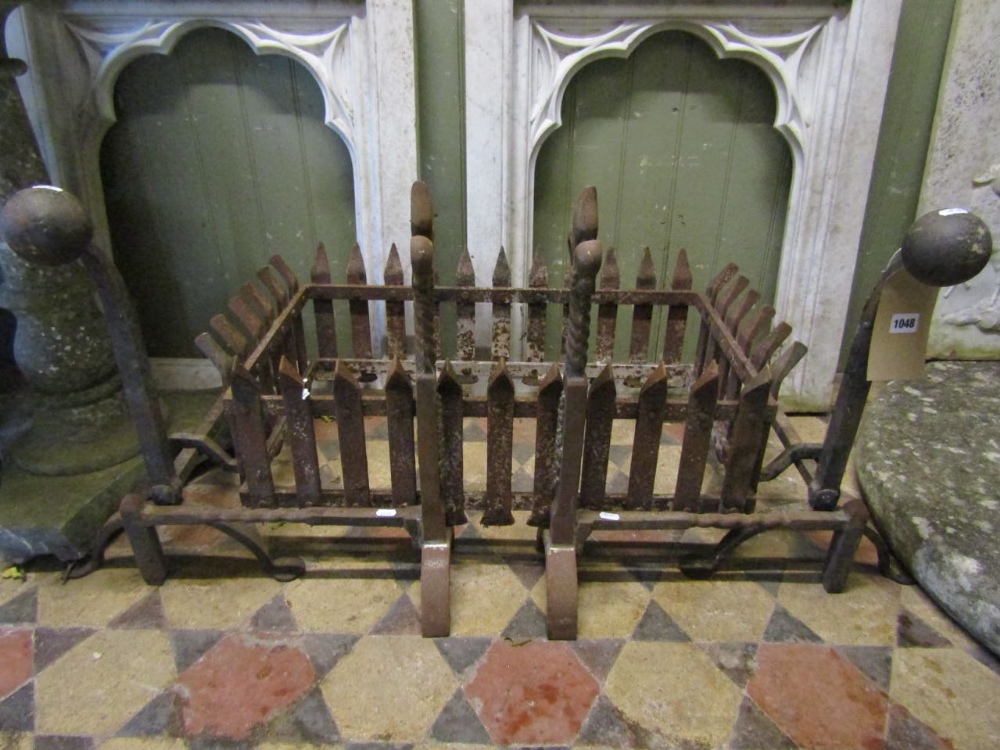 A cast iron fire basket of rectangular form with trellis surround, raised on loose fire dogs with