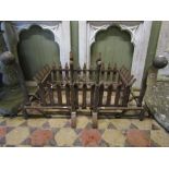 A cast iron fire basket of rectangular form with trellis surround, raised on loose fire dogs with