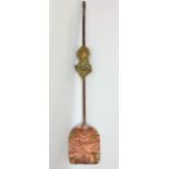 An interesting Tibetan copper shovel with brass relief decoration; together with an antique