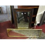 An Edwardian wall mirror of rectangular form with bevelled edge plate within a moulded oak frame