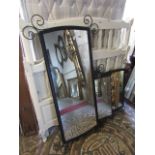 Three contemporary metal framed wall mirrors of various size and design, all with simple scroll work