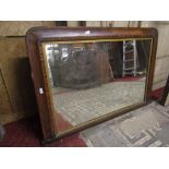 A Victorian walnut veneered chimney glass of rectangular form with inlaid straw work banding, gilded