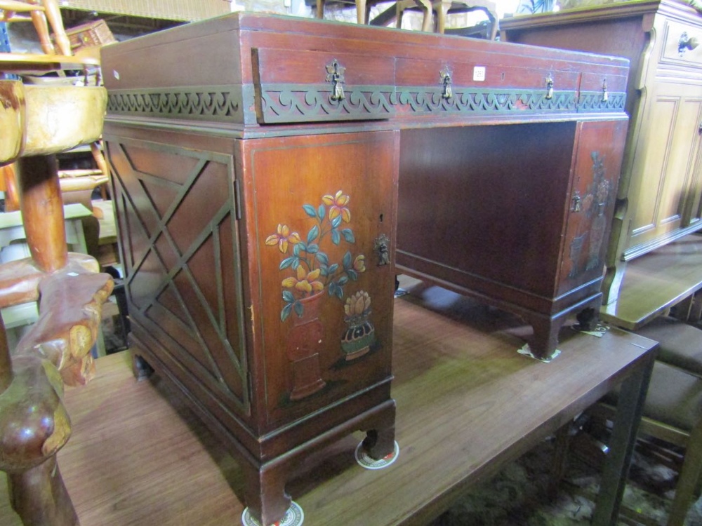 An Edwardian walnut kneehole desk in the Chinese Chippendale style with painted, fretwork and