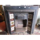 A reclaimed Victorian cast iron fire grate/insert with inset transfer printed tiled friezes and