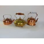 Antique copper kettle together with a further brass kettle on four feet in the arts and crafts