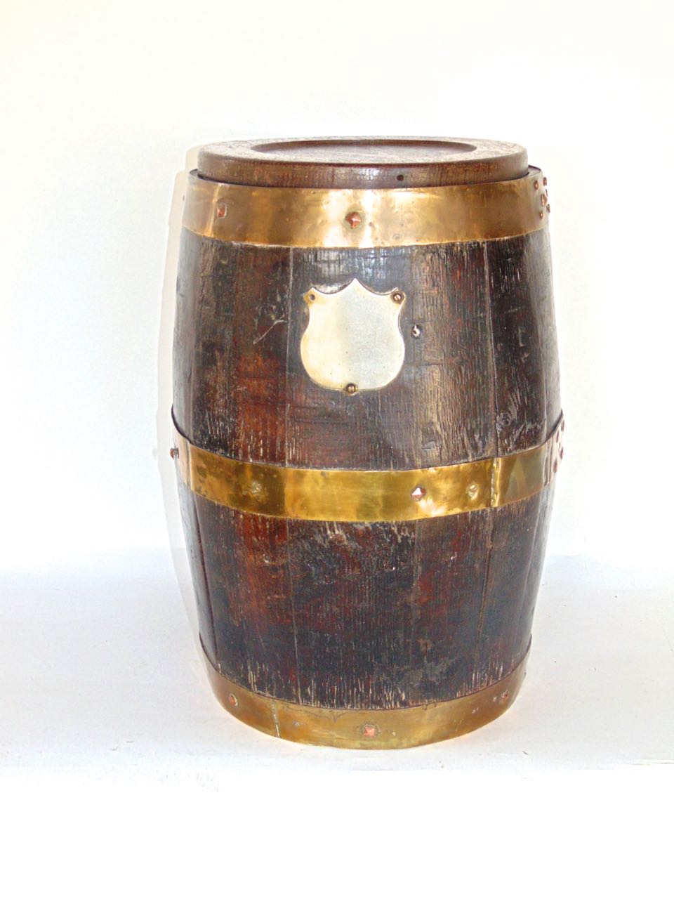 Oak and brass bound lidded barrel, with un-engraved white metal crest and copper rivets, 40cm high