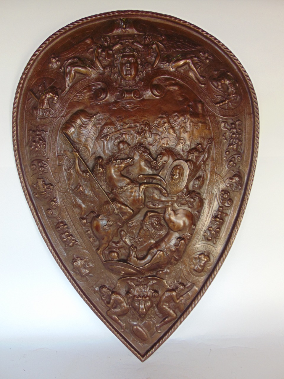 Victorian cast iron shield, a replica of the parade shield of Henry II of France, embossed with a