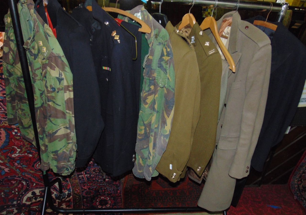 Collection of military garments including Nato army clothing and dress uniforms together with a