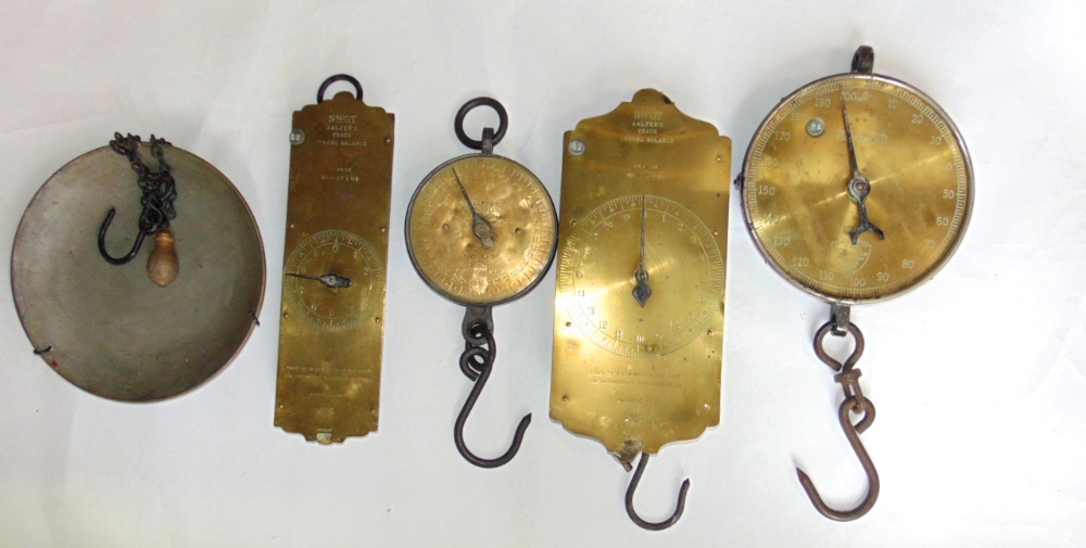 Four sets of polished brass Salter trade spring balanced scales with iron fittings