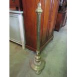 A Victorian brass lamp standard with partially reeded column, domed disc shaped platform base and