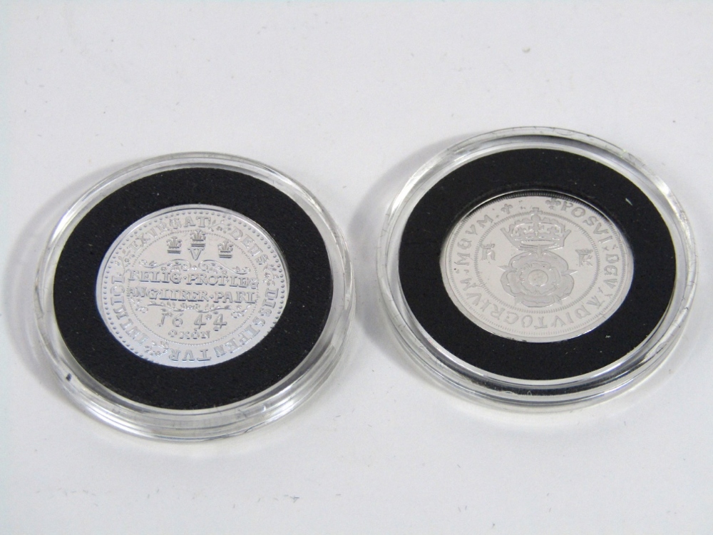 Two small replica silver coins, one depicting Henry VIII, the other a knight on horseback (2)