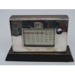 Perpetual date desk top calendar with silver frontage and wooden plinth base, 11cm high