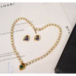 A demi parure by Bulgari comprising pearl necklace and clip earrings, the necklace set with