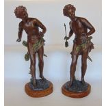 A pair of bronzed spelter figures, upon wooden plinth bases, 43cm high